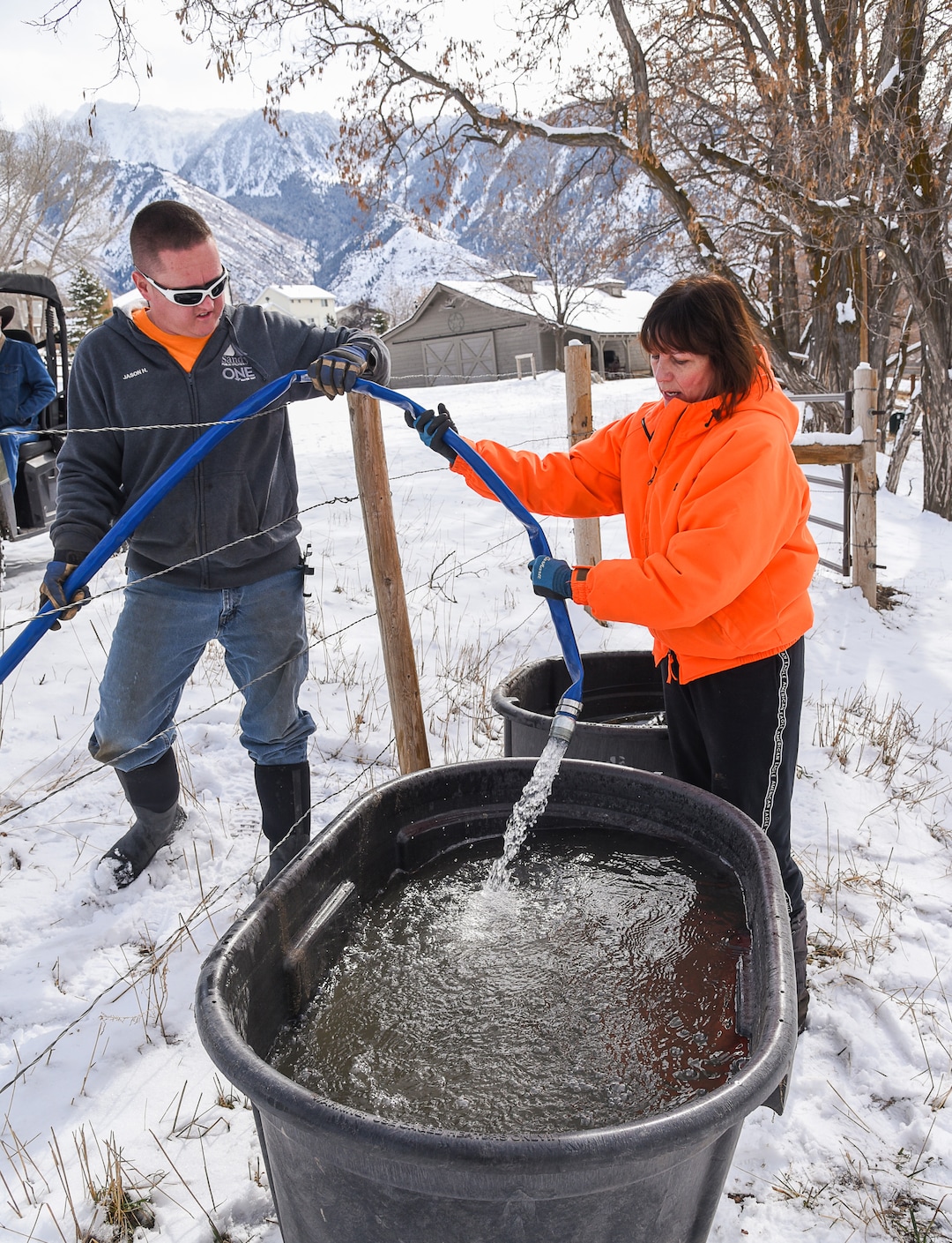 (Francisco Kjolseth  |  The Salt Lake Tribune)  Horse owner Kay Freeman has water containers filled with potable water on Sunday, Feb. 17, 2019, by Jason Hunt with Sandy City after finding out that her horses could also be affected by high levels of lead and copper in the water. The city says the problem started about Feb. 6, when a fluoride pump malfunctioned because of a power outage. It flooded the water system with fluoride and that also led to high levels of lead and copper, enough that it made some people sick.