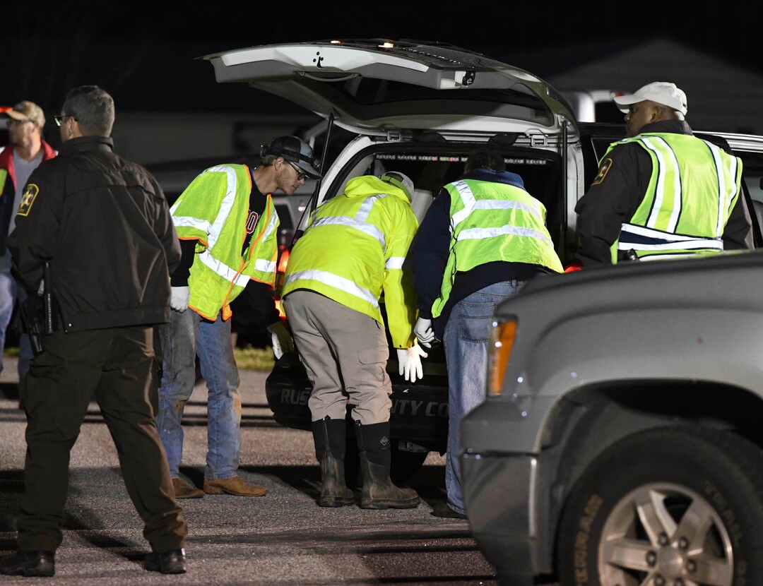 Emergency personnel work the staging area at Sanford Middle School in Beauregard, Ala., Sunday, March 3, 2019, after tornados ravaged the area, causing multiple fatalities. (AP Photo/Julie Bennett)
