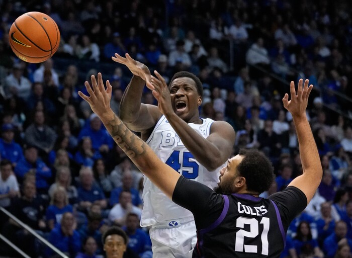 (Francisco Kjolseth | The Salt Lake Tribune) Brigham Young Cougars forward Fousseyni Traore (45) loses control of a ball against TCU Horned Frogs forward JaKobe Coles (21) during an NCAA college basketball game against TCU Saturday, March 2, 2024, in Provo, Utah.