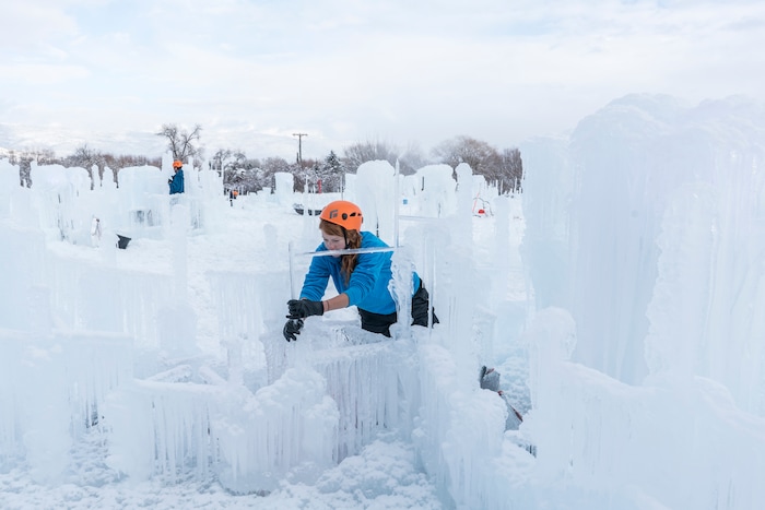 (A.J. Mellor |  courtesy of Ice Castles) An artisan works on the Ice Castles installation in Midway, Utah. The one-acre walk-through ice-and-light show is expected to open to the public in late December.
