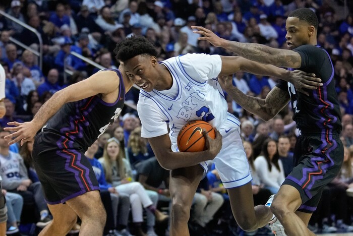 (Francisco Kjolseth | The Salt Lake Tribune) Brigham Young Cougars guard Jaxson Robinson (2) slips through the Horned Frogs during an NCAA college basketball game against TCU Saturday, March 2, 2024, in Provo, Utah.