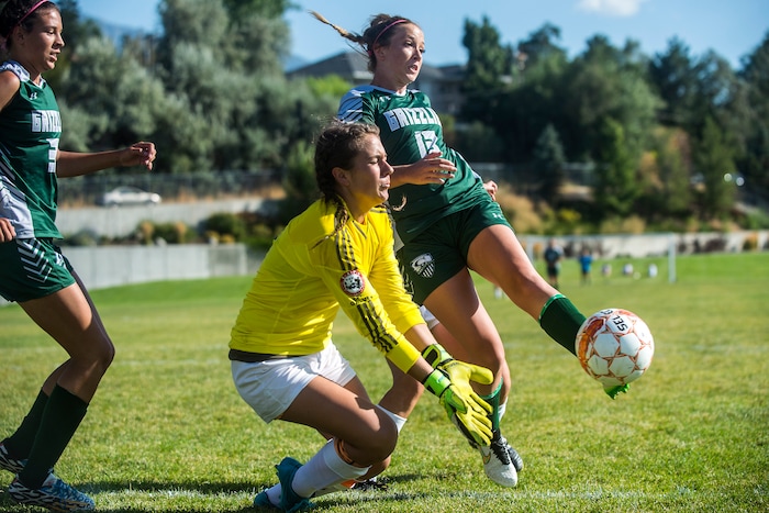 Chris Detrick  |  The Salt Lake TribuneCopper Hills' Nikki Oliver (13) kicks the ball past Brighton's AJ Parker (01) during the game at Brighton High school Tuesday September 6, 2016. The goal was not counted because of a pushing violation on Copper Hills. Copper Hills won the game 2-0. 