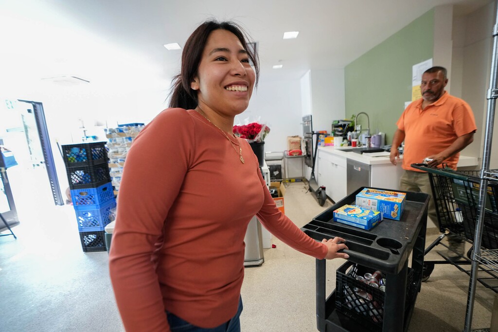 (Francisco Kjolseth | The Salt Lake Tribune) Christian Center of Park City pantry assistant Ereidy Santos works alongside Jaime Mira, deputy director of food insecurity, in the center's food pantry on Thursday, July 17, 2025. Utah nonprofits that serve immigrants have been impacted by changes from the Trump administration, a recent report found.