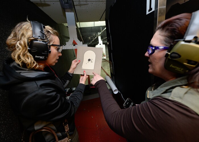 (Francisco Kjolseth  |  The Salt Lake Tribune)  Tiffany Sowder of Morgan, left, overlooks her precision with Michelle Camp, after alternating hands while shooting a 9mm at the Gun Vault shooting range in South Jordan. Sowder is part of the group The Well-Armed Woman, led by Camp in Utah, which encourages women to conceal carry for safety. Of the concealed carry permits issued by the state, only about one in five is held by a woman.