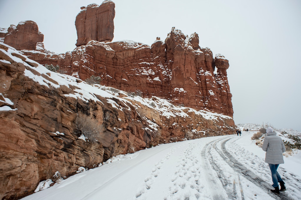 (Rick Egan  |  The Salt Lake Tribune)    Hikers trek along the closed roads inside Arches National Park on Sunday, Jan. 6, 2019.