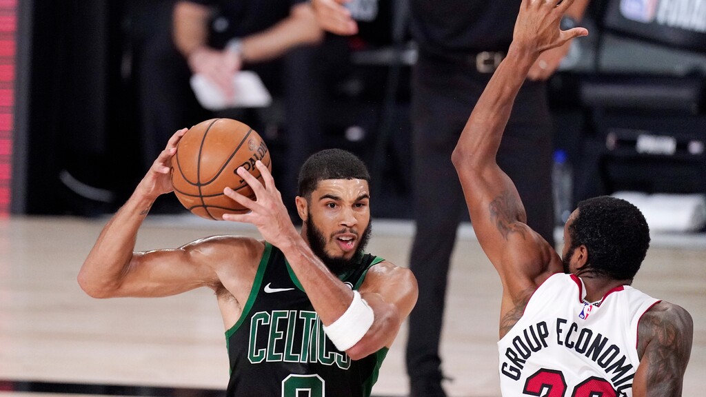 Boston Celtics' Jayson Tatum (0) is defended by Miami Heat's Andre Iguodala (28) during the second half of an NBA conference final playoff basketball game Friday, Sept. 25, 2020, in Lake Buena Vista, Fla. (AP Photo/Mark J. Terrill)