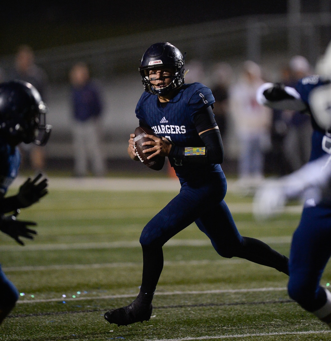 (Francisco Kjolseth  |  The Salt Lake Tribune)  Corner Canyon quarterback Zach Wilson looks for an opening in game action between Timpview at Corner Canyon on Thursday, Sept. 21, 2017.