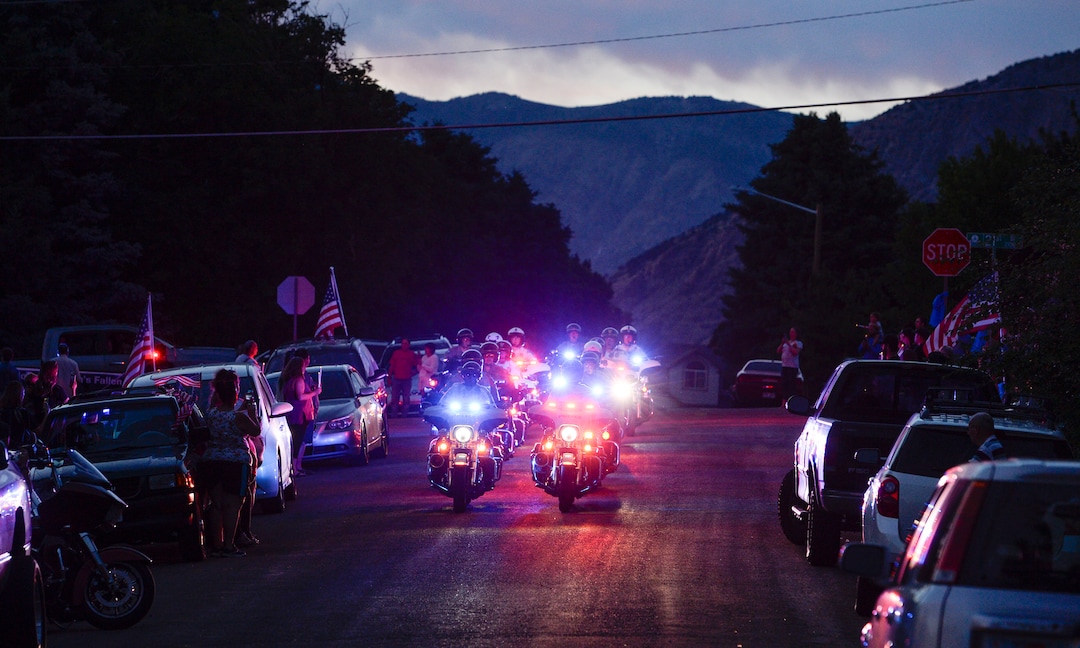 (Leah Hogsten  |  The Salt Lake Tribune) Ogden Police Department vehicles drive past Officer Nate Lyday's childhood home on Custer Avenue in Ogden in a Memorial Procession and Community Vigil in honor of Lyday's life. The procession made its way through five other Ogden landmarks before ending at Lindquist Field.