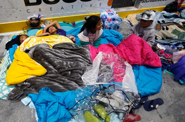 Evacuees, from left, Dennis Larios, Odaliz Larios, Jennifer Larios and Kevin Renoso, wait to leave the Germain Arena, which was used as an evacuation shelter for Hurricane Irma, which passed through yesterday, in Estero, Fla., Monday, Sept. 11, 2017. (AP Photo/Gerald Herbert)