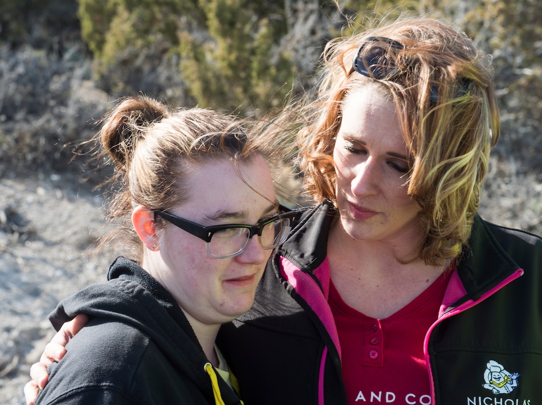 (Rick Egan  |  The Salt Lake Tribune)      Kylysta, Breezy's sister,  gets hug from Amanda Hunt, Breezy's Aunt, as they wait foras crews work to recover the two bodies that were found in an abandoned mine in Utah’s west desert near Eureka. Police believe the bodies are those of two teenagers that may be Brelynn “Breezy” Otteson, and  Riley Powell, who have been missing for nearly three months. Wednesday, March 28, 2018.