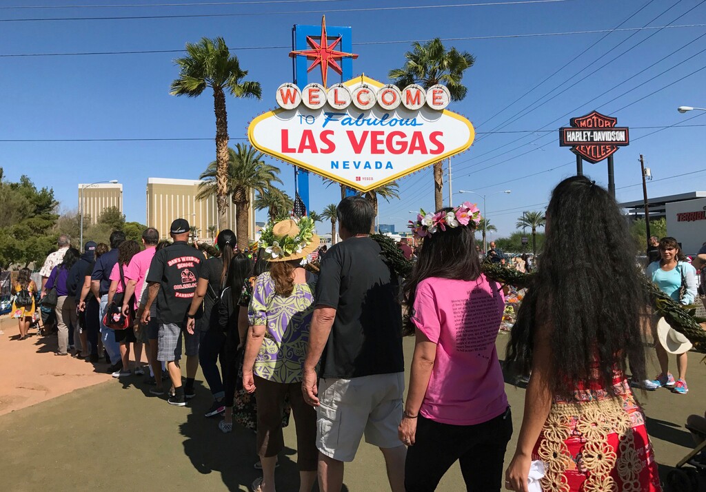 Hawaiians who now live in Las Vegas joined those who still live in the islands to deliver a special lei to the city's people in an effort to bring peace and healing to the community after the most deadly shooting in modern U.S. history on Saturday, Oct. 14, 2017 in Las Vegas. The largest of the three ceremonies Saturday took place outside the iconic "Welcome to Fabulous Las Vegas" sign. (AP Photo/Anita Snow)