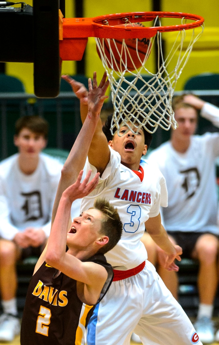 (Steve Griffin  |  The Salt Lake Tribune) Davis Trevan Leonhardt gets his shot blocked by Granger's Jeremiah Semeli during the Granger versus Davis 6A basketball playoff game at Utah Valley UniversityÕs UCCU Center in Provo Tuesday Feb. 27, 2018.