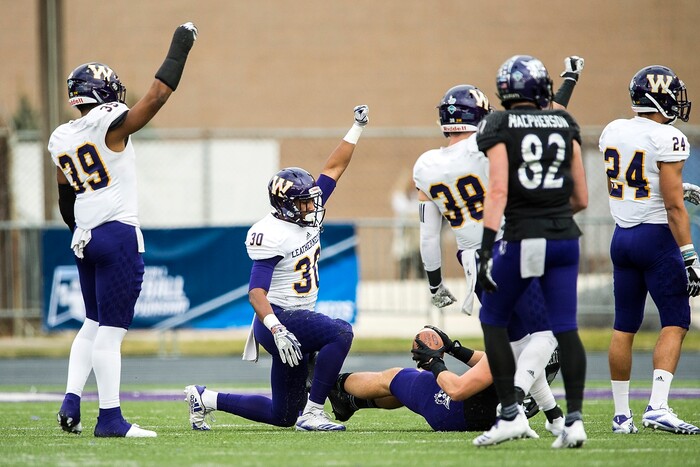 (Chris Detrick  |  The Salt Lake Tribune)  Western Illinois Leathernecks linebacker Quentin Moon (39) Western Illinois Leathernecks defensive back Justin Fitzpatrick (30) and Western Illinois Leathernecks defensive back David Griffith (38) celebrate after stopping Weber State Wildcats tight end Andrew Vollert (87) during the game at Stewart Stadium Saturday, November 25, 2017.  