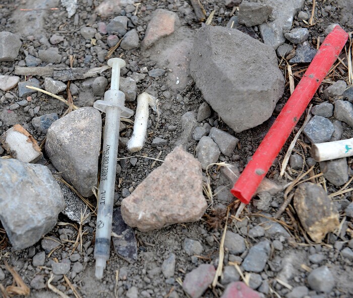 (Al Hartmann  |  The Salt Lake Tribune) A used hypodermic needle used to shoot heroin and a straw used to inhale burning heroin from tinfoil in the Rio Grande neighborhood on Wednesday, July 19.