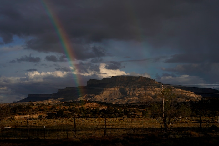 A rainbow is seen in the distance from the closed Chilchinbeto Church of the Nazarene in Chilchinbeto, Ariz., on the Navajo reservation on April 21, 2020. The reservation has some of the highest rates of coronavirus in the country. If Navajos are susceptible to the virus' spread in part because they are so closely knit, that's also how many believe they will beat it. (AP Photo/Carolyn Kaster)