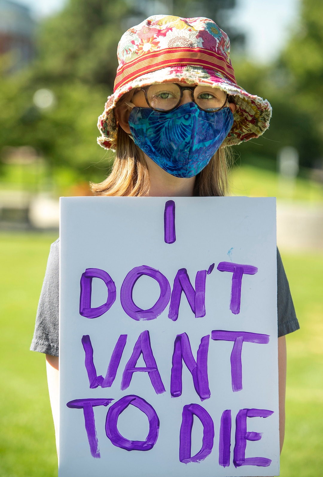 (Rick Egan  |  The Salt Lake Tribune)   ]Aven Bailey holds a sign for the Mask-In and Car Caravan protest at the State Capitol to demand the Governor and other state and local leaders ensure that Utah school protect students and staff when schools reopen, on Thursday, July 23, 2020.