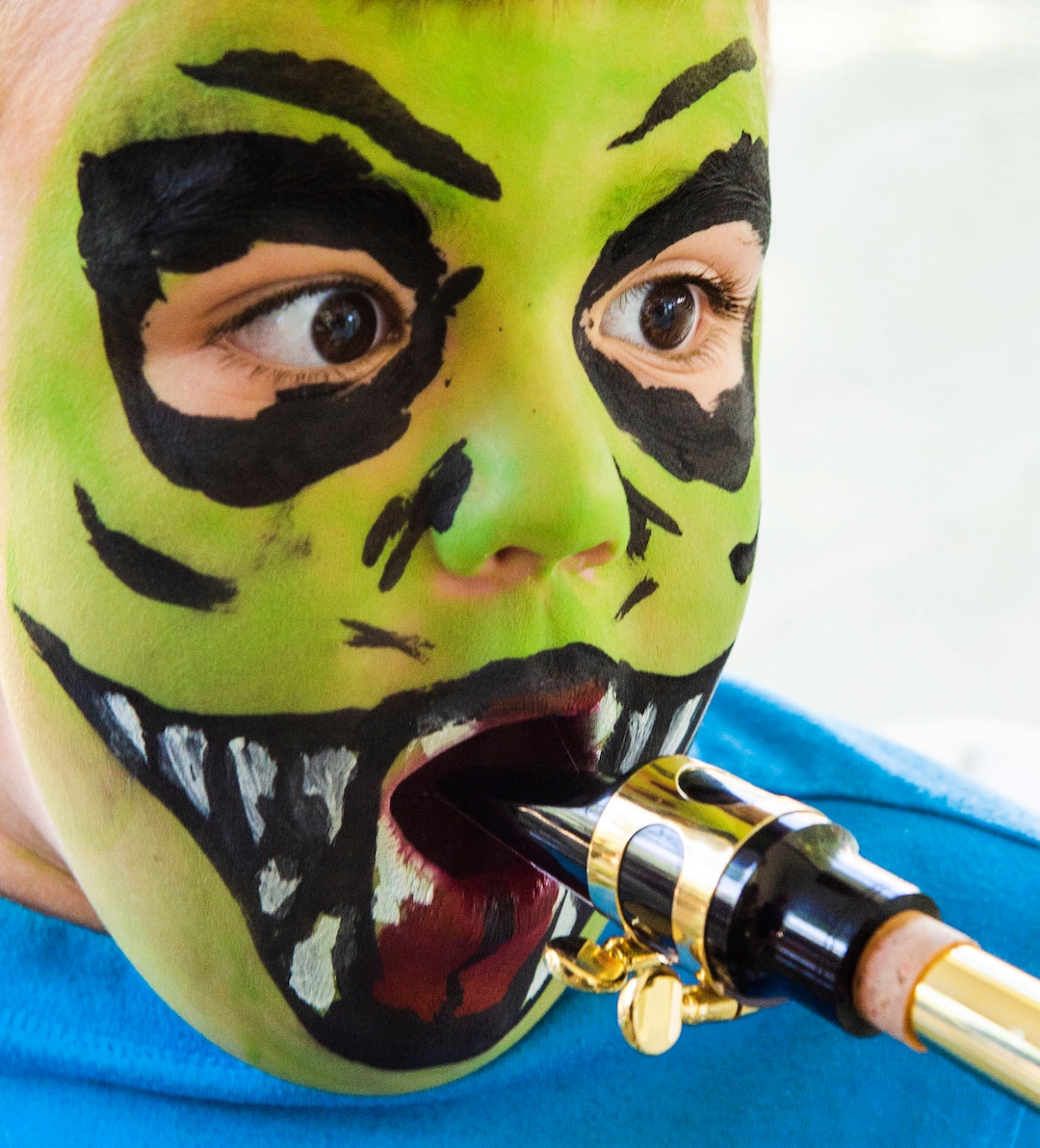 (Rick Egan  |  The Salt Lake Tribune)   Hendrix Ford, 5, toots on a trombone in the Art Yard, at the Utah Arts Festival, Saturday, June 22, 2019.