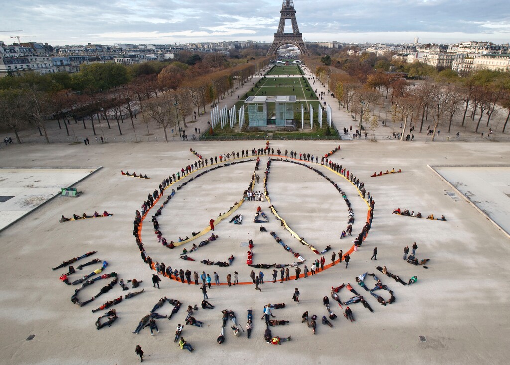 (AP PhotoMichel Euler, File) In this Dec. 6, 2015 file photo, environmentalist activists form a human chain representing the peace sign and the spelling out "100% renewable", on the side line of the COP21, United Nations Climate Change Conference near the Eiffel Tower in Paris. Four months after negotiating a global climate agreement in Paris, government officials are coming to New York on Friday, April 22, 2016, to sign the pact in a ceremony at the United Nations.