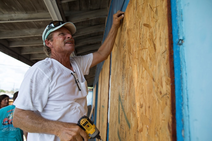 (Courtney Sacco | Corpus Christi Caller-Times) Mark Jones helps board up windows at Deep Sea Headquarters in Port Aransas, Texas, ahead of Tropical Storm Harvey on Thursday, Aug. 24, 2017. Tropical Storm Harvey intensified Thursday into a hurricane that forecasters said would be the first major hurricane to hit the middle Texas coastline in nearly 15 years.