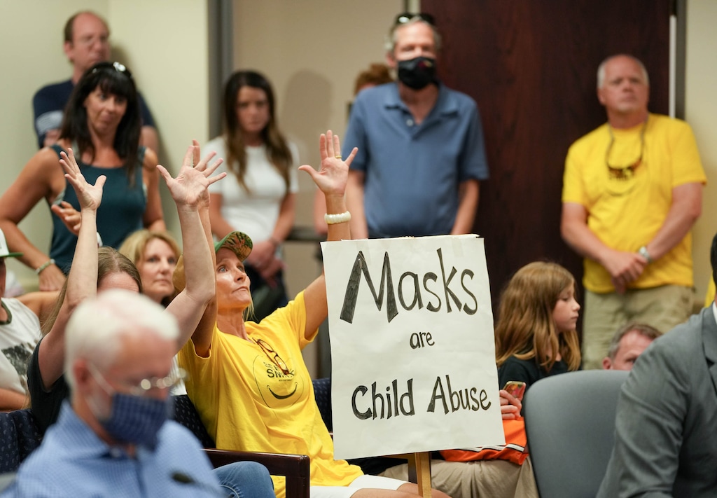 (Francisco Kjolseth | The Salt Lake Tribune) Rebecca Olson of Highland, expresses her opposition to any possible future mask mandates in schools as she shakes her hands in quiet support of those speaking in opposition to masks to the Salt Lake County Council during a council meeting on Tuesday, Aug. 3, 2021.