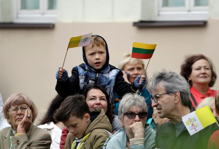 (Andrew Medichini  |  AP Photo)  A child waves a Vatican flag, left, and a Lithuanian flag as he waits for Pope Francis to arrive ahead of a meeting with authorities, civil society and diplomatic corps in the square in front of the Presidential Palace, in Vilnius, Lithuania, Saturday, Sept. 22, 2018. Pope Francis begins a four-day visit to the Baltics amid renewed alarm about Moscow's intentions in the region it has twice occupied.