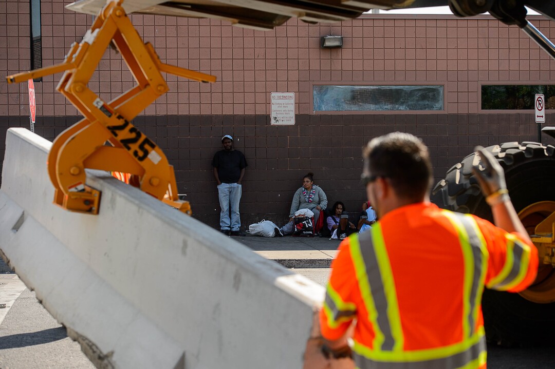 (Trent Nelson | The Salt Lake Tribune)  Workers install barriers on Rio Grande in Salt Lake City to prevent auto traffic in hopes of stopping the drug traffic around the area, Friday September 1, 2017.