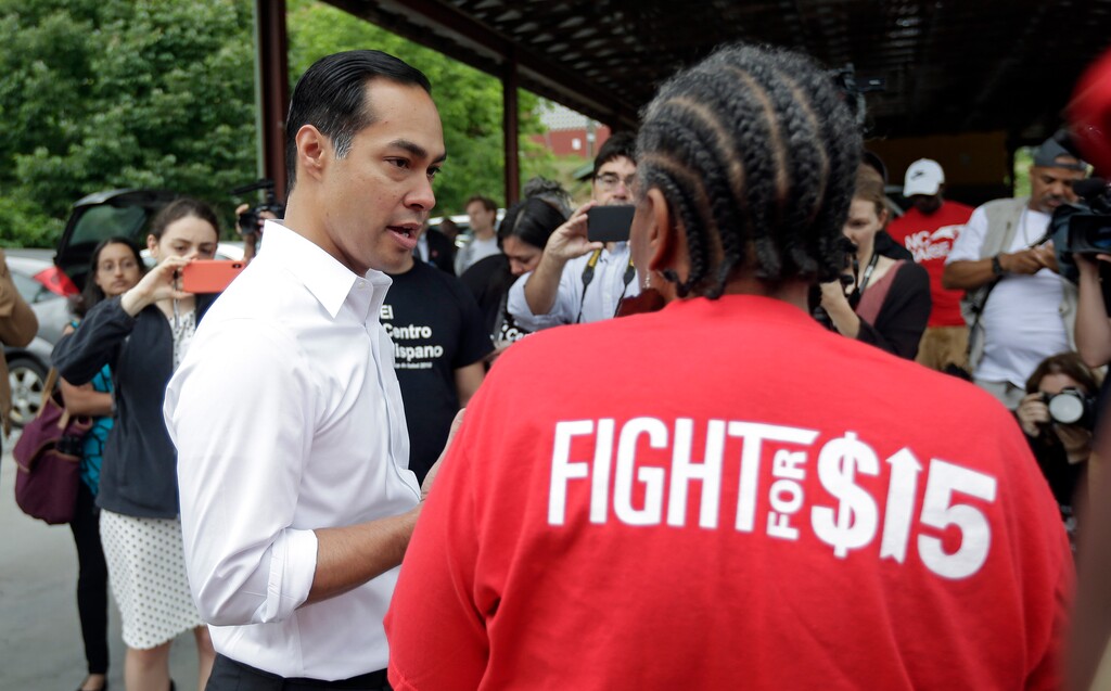 (Gerry Broome | AP Photo) Presidential candidate and former U.S. Department of Housing and Urban Development Julian Castro speaks with a supporter prior to rallying with McDonald's employees and other activists demanding fairer pay, better working conditions, and the right to unionize in Durham, N.C., Thursday, May 23, 2019.