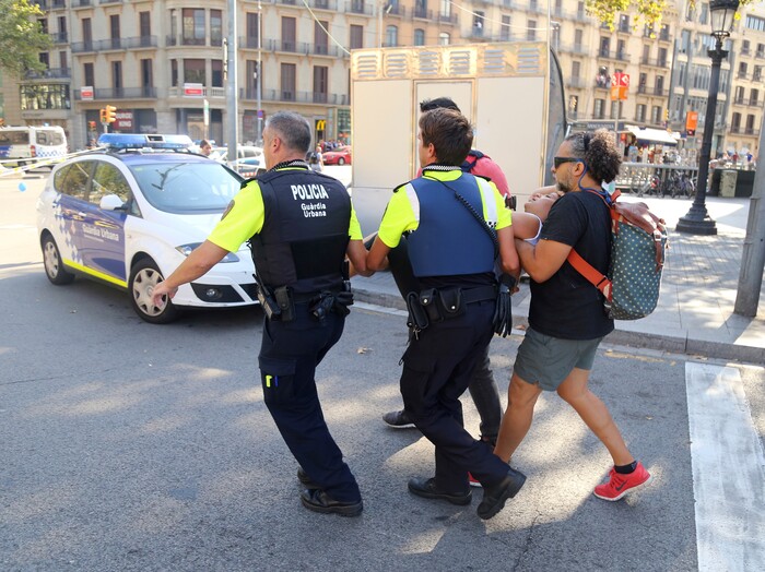 (Oriol Duran | The Associated Press) A person is carried in Barcelona, Spain, Thursday, Aug. 17, 2017 after a white van jumped the sidewalk in the historic Las Ramblas district, crashing into a summer crowd of residents and tourists and injuring several people, police said.