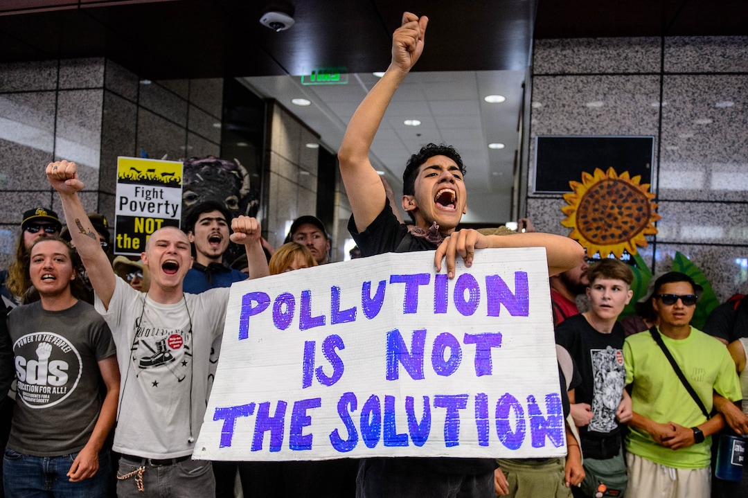 (Trent Nelson  |  The Salt Lake Tribune) Protesters occupy the Chamber of Commerce Building in Salt Lake City on Tuesday, July 9, 2019. Dozens of people showed up to protest the planned Inland Port. The protest began at City Hall and moved to the Chamber of Commerce.