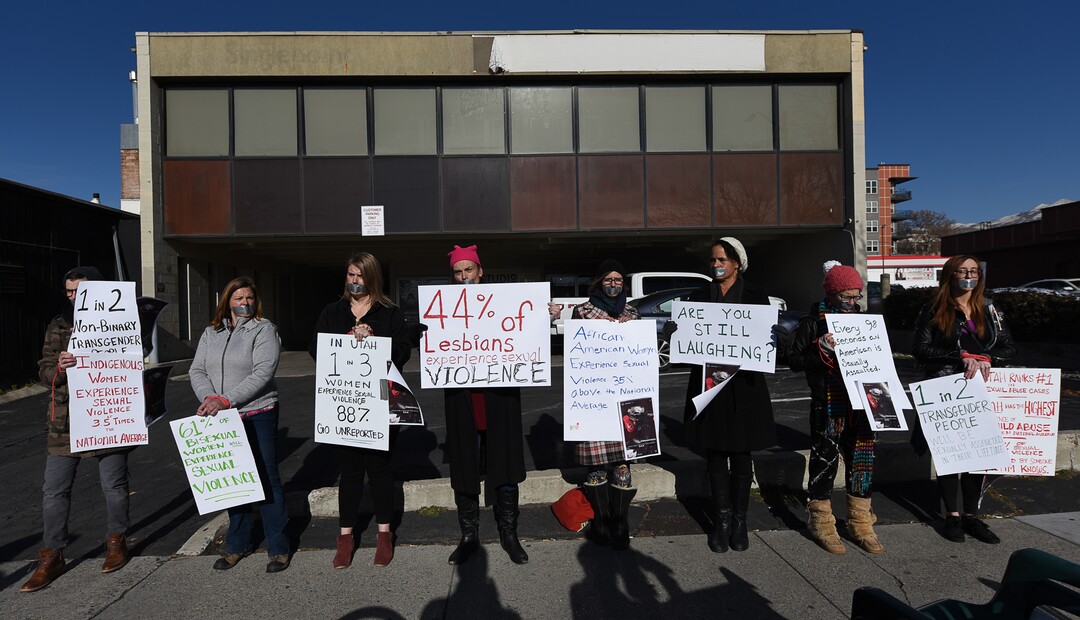 (Francisco Kjolseth  |  The Salt Lake Tribune)  Taking a stand against the normalization of rape and sexual violence, activists in Utah gather outside of Salt City Tattoo on Friday, Dec. 22, 2017,  to protest following an Instagram post made by the shop's official Instagram account. The post in question was of a gift provided during the shop's white elephant exchange, a gift one of the artists at the parlor called a "rape kit," containing leather gloves, black duct tape, a bottle of lubricant, rope, and a knife.
