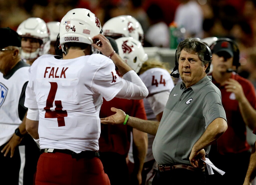 Washington State coach Mike Leach, right, talks to quarterback Luke Falk in the first half during an NCAA college football game against Arizona, Saturday, Oct. 28, 2017, in Tucson, Ariz. (AP Photo/Rick Scuteri)