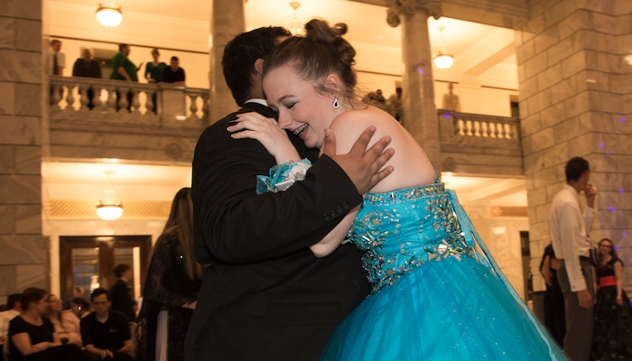 (Leah Hogsten  |  The Salt Lake Tribune) Jadelyn Christensen hugs her date Christopher Tschudy on the dance floor. Three virtual charterÊschools, Utah Virtual Academy, Utah Connections Academy and Mountain Heights Academy, co-hosted prom for their students, Friday, April 27, 2018. 