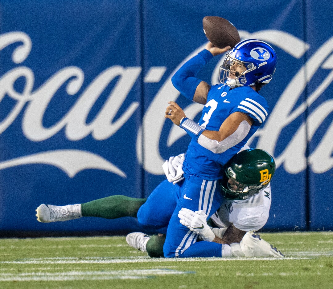 (Rick Egan | The Salt Lake Tribune)  Brigham Young Cougars quarterback Jaren Hall (3), get rid of the ball as he is brought down by the Baylor defender, in football action between the Brigham Young Cougars and the Baylor Bears at LaVell Edwards Stadium in Provo, on Saturday, Sept. 10, 2022.