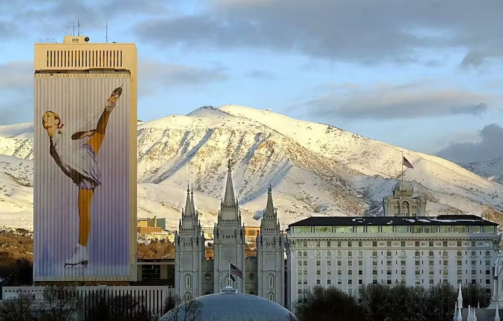 (George Frey | AFP via Getty Images) The Latter-day Saints temple in downtown Salt Lake City, center, as an Olympic banner drapes the church office building next door during the 2002 Games.