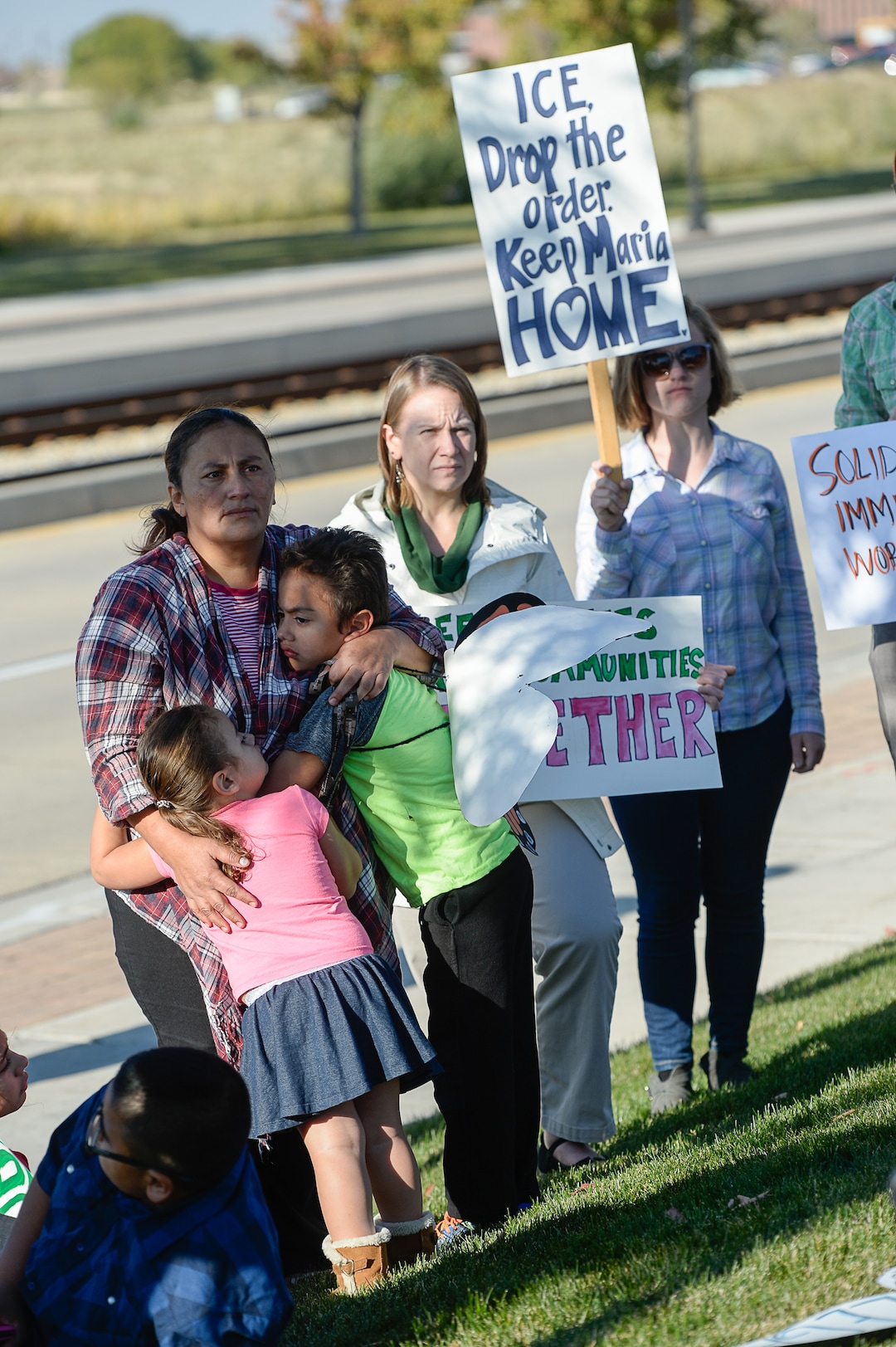 (Francisco Kjolseth  |  The Salt Lake Tribune)  Maria Santiago Garcia is embraced by her children Natalie and Anthony Fajardo as community members rally in front of the Immigration and Customs Enforcement offices in West Valley City on Monday, Oct. 16, 2017, to support her. The single Utah mother of four U.S. born children faces an impending deportation order.