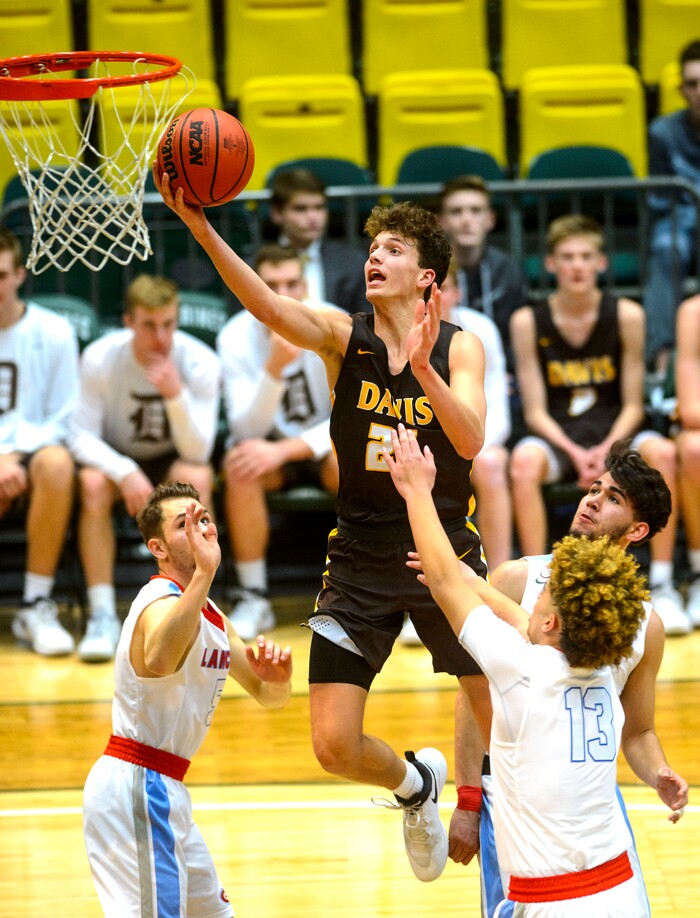 (Steve Griffin  |  The Salt Lake Tribune) Davis guard Tyson Garff splits the Granger defense during the 6A basketball playoff game at Utah Valley UniversityÕs UCCU Center in Provo Tuesday Feb. 27, 2018.