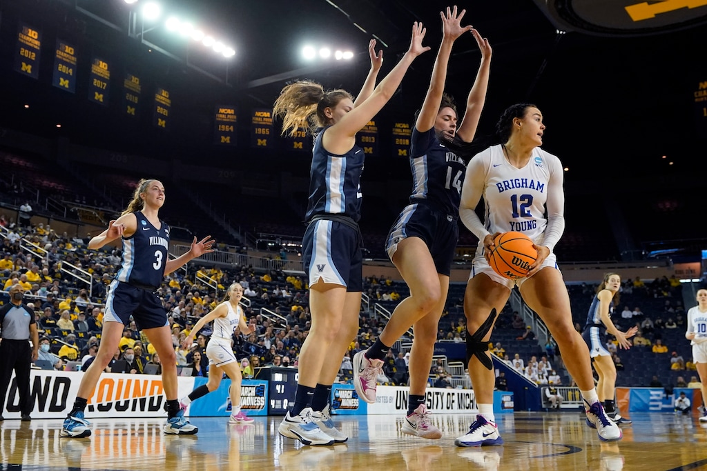 BYU forward Lauren Gustin (12) looks to pass as Villanova forward Brianna Herlihy (14) defends during the second half of a college basketball game in the first round of the NCAA tournament, Saturday, March 19, 2022, in Ann Arbor, Mich. (AP Photo/Carlos Osorio)