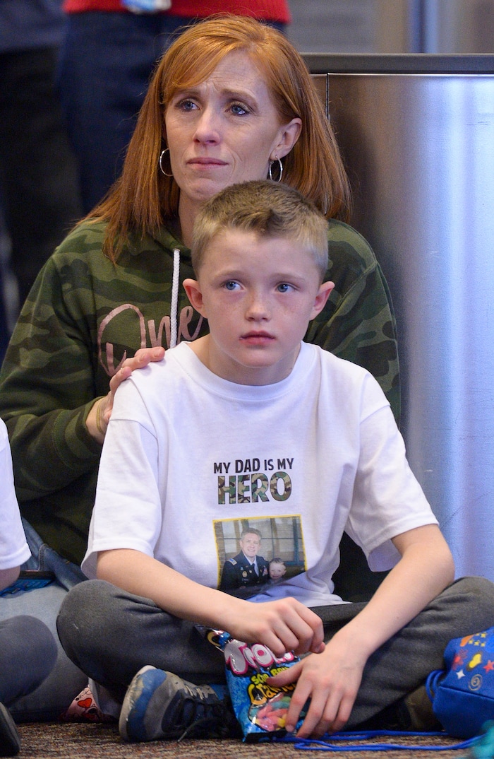 (Leah Hogsten | The Salt Lake Tribune) Jennie Taylor, the widow of Maj. Brent Taylor, and her son Jacob, watch a dance troupe before boarding their flight. Ten Gold Star families from Salt Lake City were treated to a Winter Wonderland scene, including Whoville and the Grinch at their boarding gate at Salt Lake International Airport, Dec. 7, 2019 before their flight to Disney World aboard the Snowball Express. This month, the Gary Sinise Foundation's Snowball Express will fly more than 1,700 family members of fallen U.S. military heroes to Disney World for a holiday retreat.
