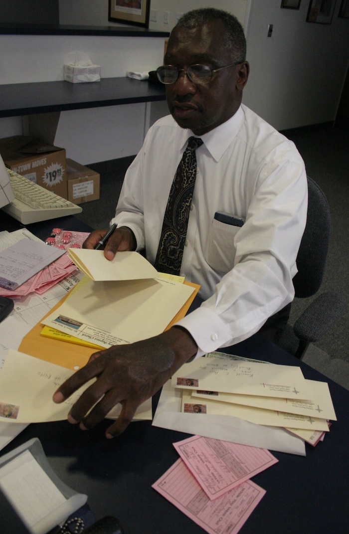 (Jim Urquhart | Tribune file photo) Rev. France Davis writes thank you letters to all those who donated good and supplies to hurricane Katrina victims, Sept. 8, 2005.