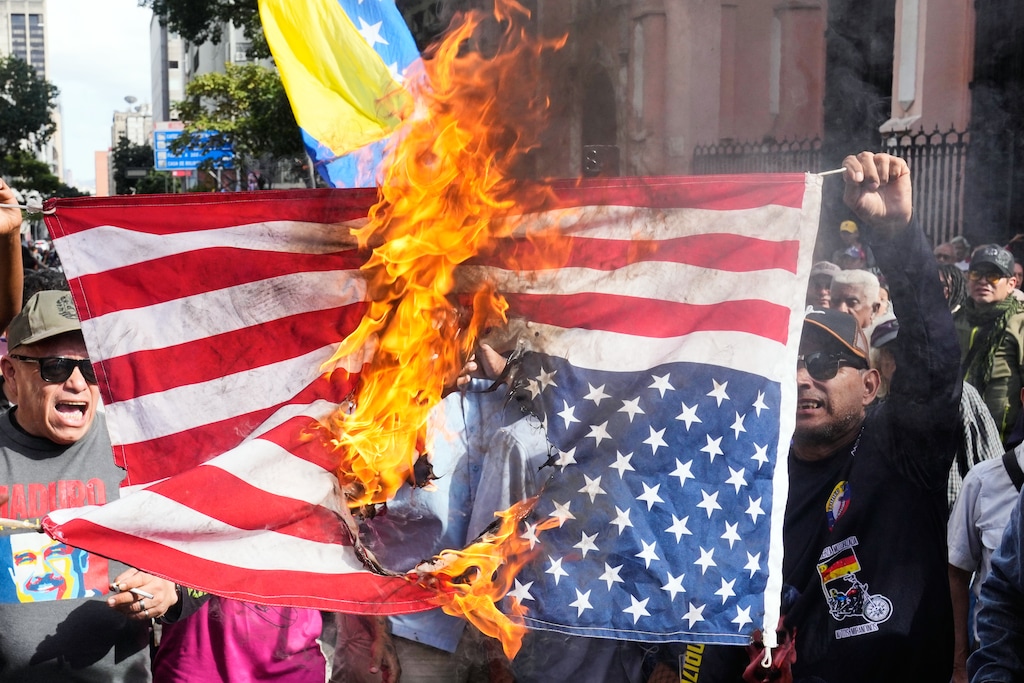 (Ariana Cubillos | AP) Government supporters burn a U.S. flag in Caracas, Venezuela, Saturday, Jan. 3, 2026, after U.S. President Donald Trump announced that U.S. forces had captured Venezuelan President Nicolás Maduro and his wife.