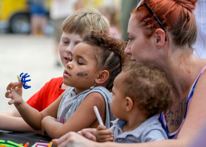 (Leah Hogsten | The Salt Lake Tribune) l-r Iylah Kembo, 4, marvels at her handmade spider with her mother Aubrey and brother Mehki, 1, at the Antelope Island Spider Fest 2019 at Antelope Island State Park, August 3, 2019. Spider Fest featured a day full of spider-themed presentations, crafts, guided walks, citizen science, poetry, photography, art and educational presentations about the arachnids on the island.