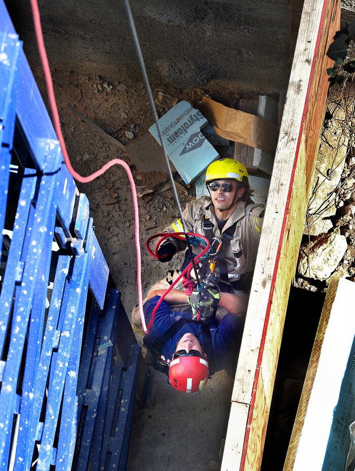 (Scott Sommerdorf | The Salt Lake Tribune) Firefighter Rob Takeno, top, of the Park City Fire District special operations team practices a tower crane operator rescue with firefighter Steve Jensen, left, acting as the victim, as they are slowly lowered to the ground. The high mountain rescue training exercise utilized a Jacobsen tower crane and operator at the construction site of the One Empire Pass development at Deer Valley, Sunday, Aug. 20, 2017.