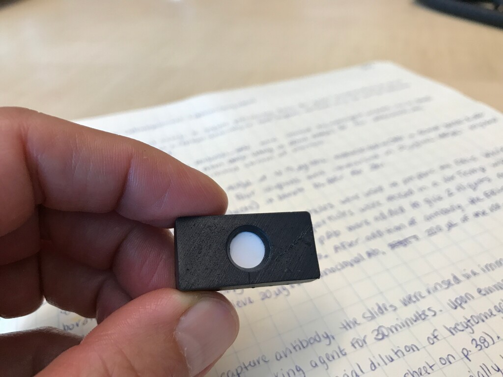 (Courtesy of the University of Utah) A portable liver cancer screening test, recently developed on the University of Utah campus, works like an at-home pregnancy test. Blood, saliva, urine or tear drops can be collected in a domino-sized cartridge containing paper that identifies key proteins specific to a disease.