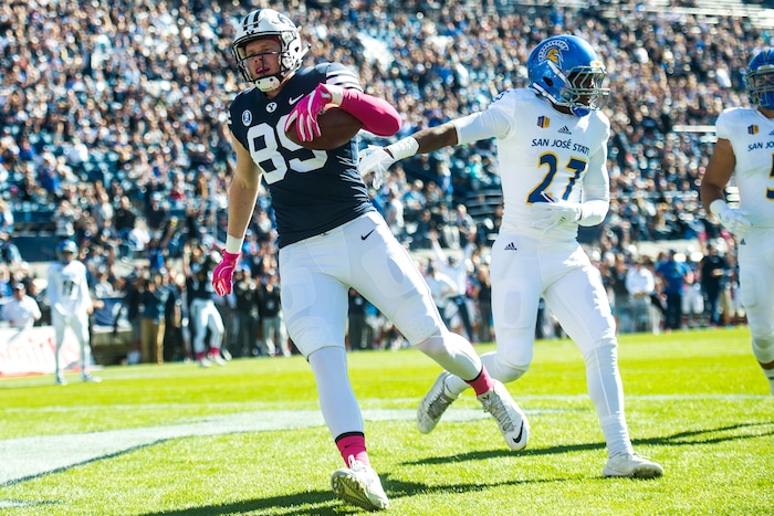 (Chris Detrick  |  The Salt Lake Tribune)  Brigham Young Cougars tight end Matt Bushman (89) scores a touchdown past San Jose State Spartans safety Jonathan Lenard Jr. (27) during the game at LaVell Edwards Stadium Saturday, October 28, 2017.  