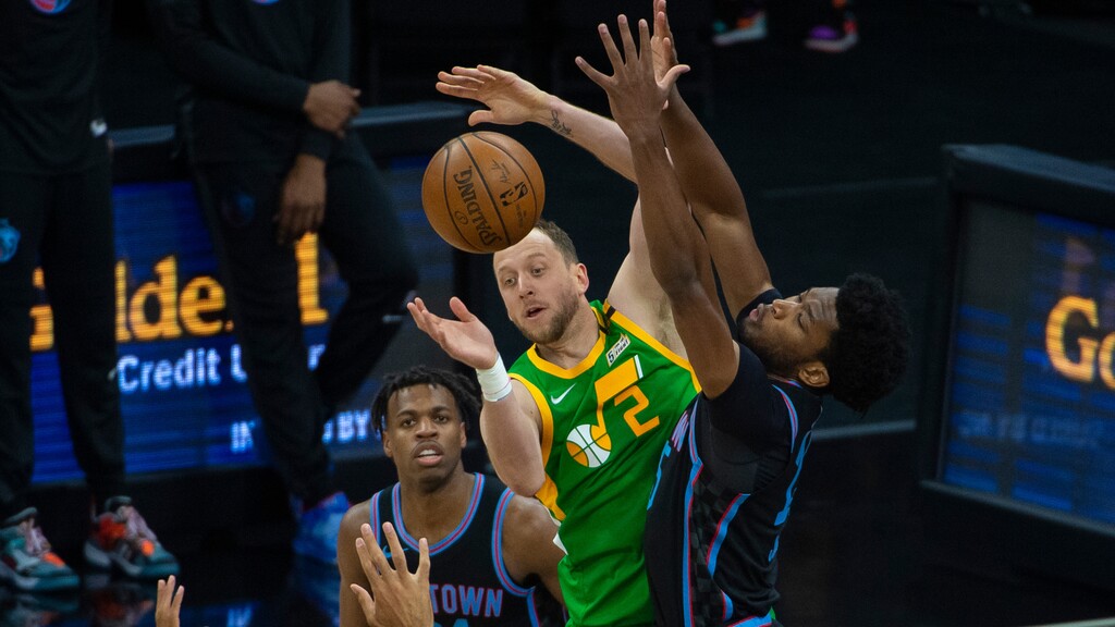Utah Jazz guard Joe Ingles (2) passes the ball past Sacramento Kings center Damian Jones during the first quarter of an NBA basketball game in Sacramento, Calif., Sunday, May 16, 2021. (AP Photo/Randall Benton)