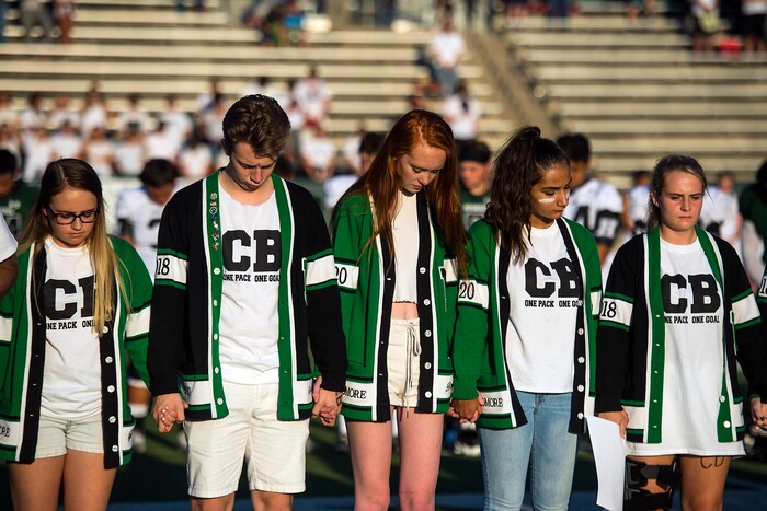 (Chris Detrick  |  The Salt Lake Tribune)    Hillcrest students during a moment of silence for Hillcrest football coach Cazzie Brown before the game at Hillcrest High School Friday, September 1, 2017. Cazzie Brown passed away Sunday night after spending four days in the hospital. According to a family representative, Brown was brought to the emergency room Wednesday for complications with his thyroid. The doctors found that he had contracted meningitis, and later received a preliminary positive after being tested for West Nile virus. 