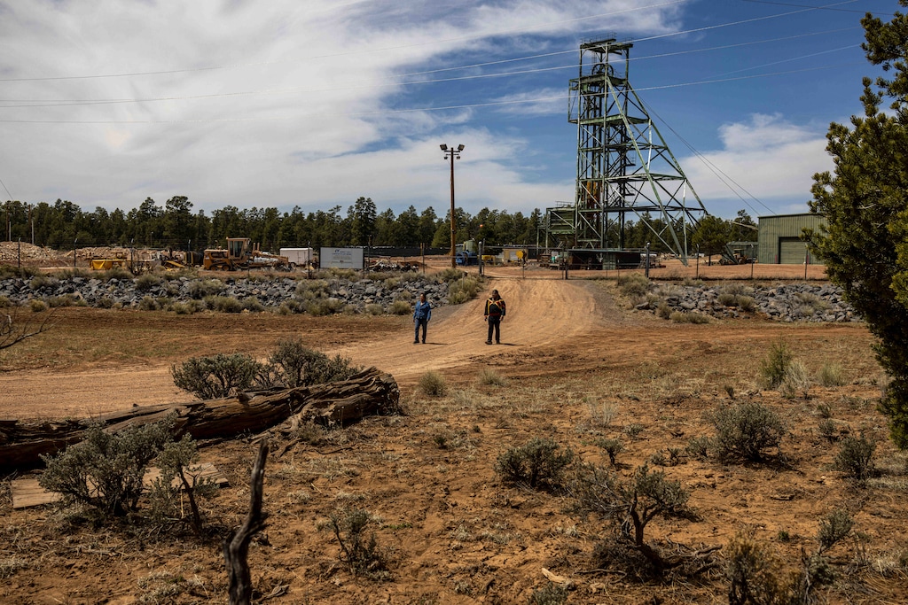 (Sharon Chischilly | The New York Times) Carletta Tilousi, left, and Stuart Chavez walk near the Pinyon Plain Mine (formerly known as Canyon Mine), located less than 10 miles from the southern rim of the Grand Canyon near Flagstaff, Arizona, April 18, 2022. The Navajo Nation recently passed new rules for the transportation of radioactive material across the reservation, following the unannounced transport of uranium ore from Pinyon Plain Mine to Utah in July.