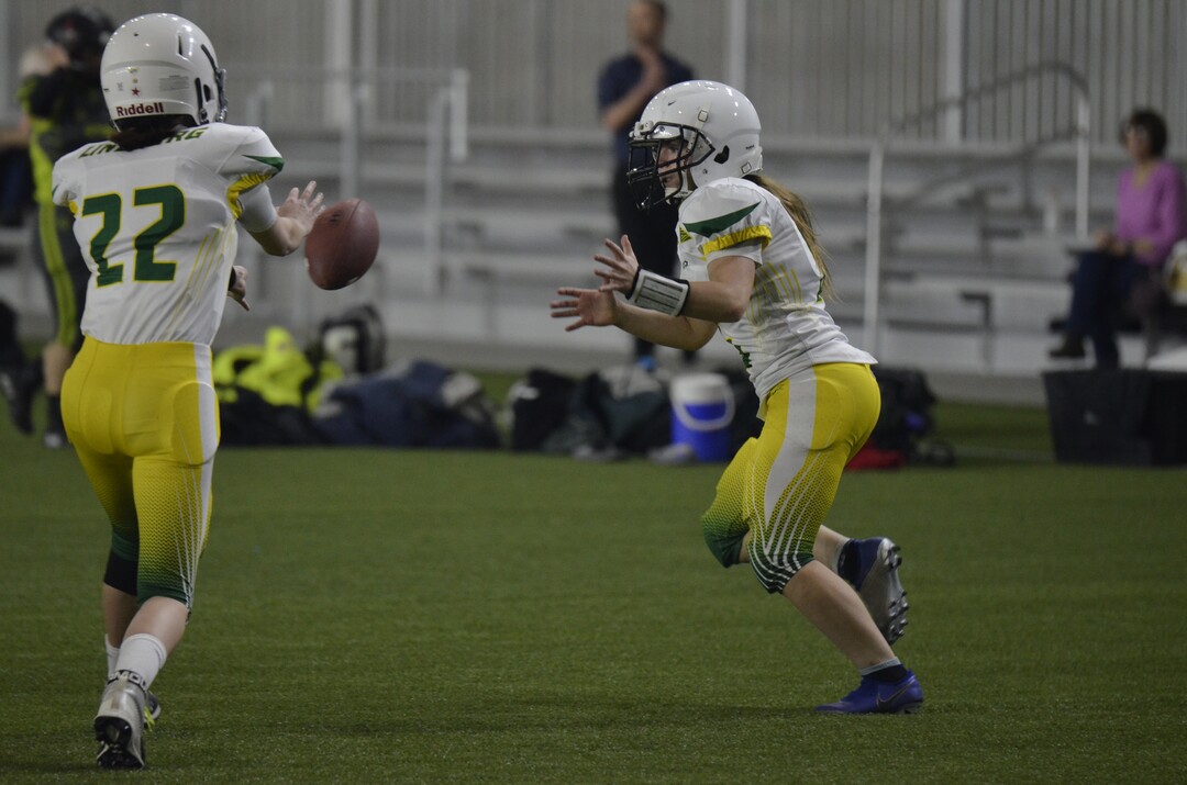 (Alex Vejar | The Salt Lake Tribune)  Mountain Ridge junior Sam Gordon receives a pitch from Mountain View’s Cassidy Lindberg during a practice of the Utah Girls’ Tackle Football League on Wednesday, Jan. 22, 2020, at the Zions Bank Training Center in Herriman.
