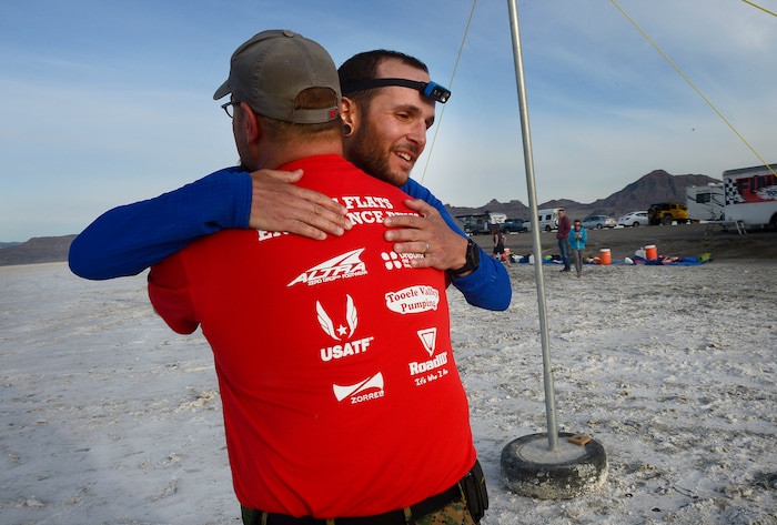 (Scott Sommerdorf | The Salt Lake Tribune)
Alex Doolan gets a hug after crossing the finish line in 8th place at the Salt Flats 100 Endurance Run, Saturday, May 5, 2018. Doolan finished in 8th place.
