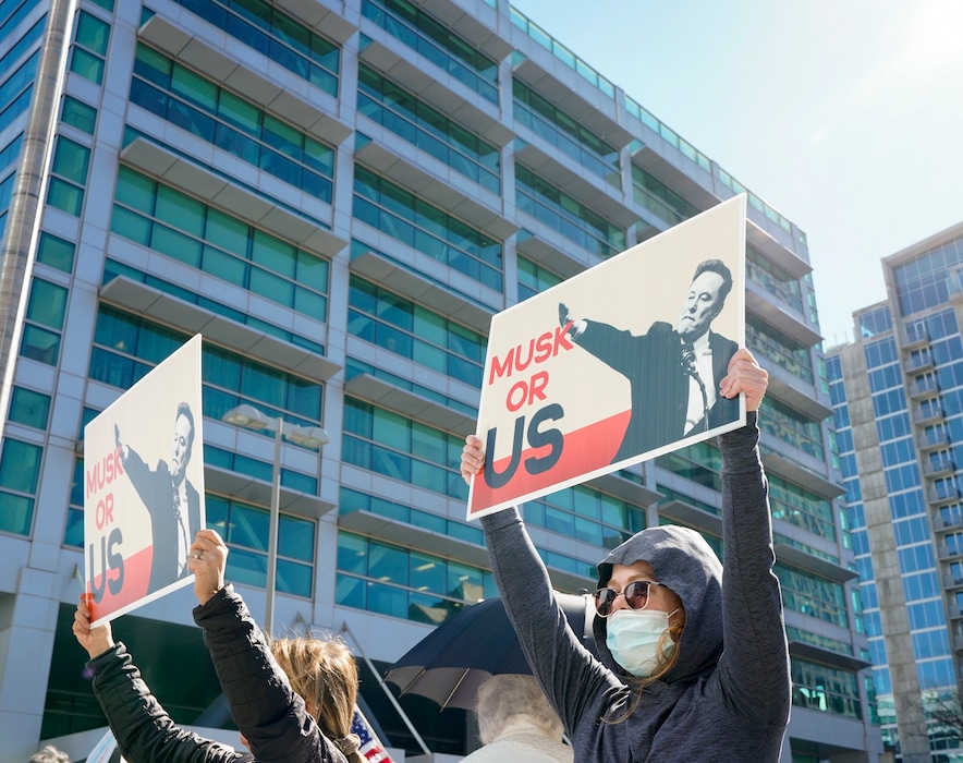 (Chris Samuels | The Salt Lake Tribune) People participate in a protest against Elon Musk and the Trump administration outside the Wallace F. Bennett Federal Building in Salt Lake City, Wednesday, Feb. 26, 2025. The Trump administration has marked the building "for disposal" as part of its push to cut federal spending.